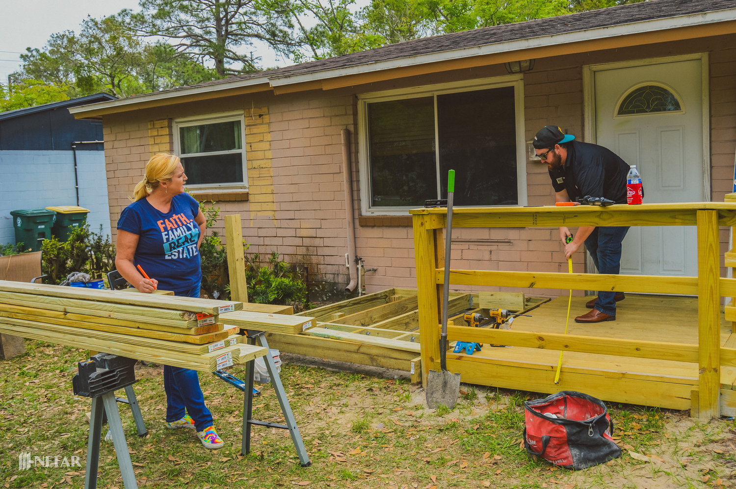 NEFAR members Renea Lee Osborne of Florida Homes Realty and Mortgage in Mandarin and John Bayer of Coldwell Banker Vanguard Realty in Ponte Vedra Beach, work on building a wheelchair ramp for a disabled Southside couple March 23.